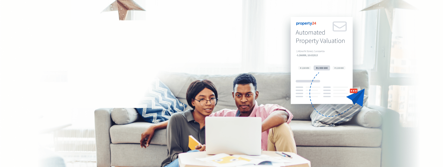 Two people sitting with a laptop, requesting a property valuation